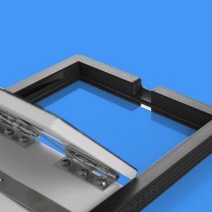 May include: A black plastic frame with a hinged lid. The lid is open and the frame is reflecting the blue background.