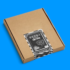 May include: A brown cardboard box with a black and white label that says "ZEBRA Wet Plate TINYTYPES" and "OPEN ONLY IN A DARK ROOM". The label also includes a zebra illustration and the text "8x10".