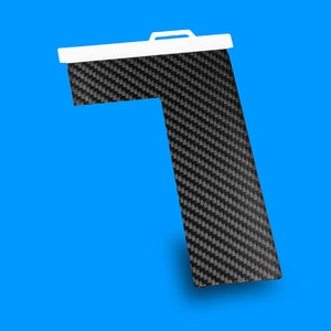 May include: A black and white carbon fiber L-shaped bracket with a white plastic handle.