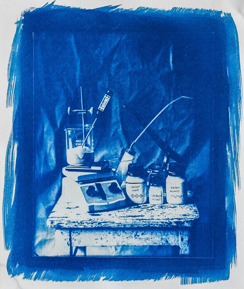 May include: A blue and white laboratory setup with a beaker, a stirring motor, and three glass jars labelled "Randy's Blend", "Speedo Mix", and "Randy's Blend".