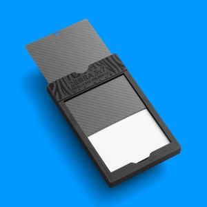 May include: A black box with a zebra print design and the text "ZEBRA 5x7 DUAL-GATE MONITOR" on the front. The box is open and a white card is visible inside.