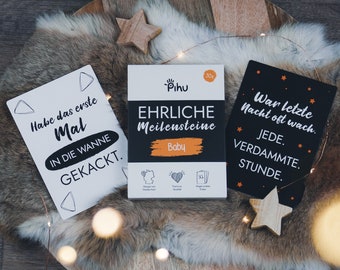 May include: A set of 30 baby milestone cards featuring a white box labelled Pihu Ehrliche Meilensteine Baby, alongside two cards with German text: Habe das erste Mal in die Wanne gekackt and War letzte Nacht oft wach. Jede. Verdammte. Stunde.