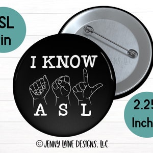 May include: A black button pin with the text "I KNOW ASL" in white, with hand gestures representing the letters. The pin is 2.25 inches in diameter. A teal circle with "ASL Pin" is in the upper left corner.