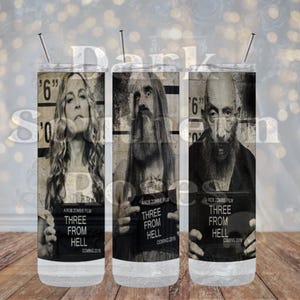 May include: Three 20 oz. stainless steel tumblers with a black and white image of characters from the movie "Three From Hell". The tumblers have a black and white mugshot style image of Sid Haig, Bill Moseley, and Sheri Moon Zombie. The text "Three From Hell" is printed on each tumbler.