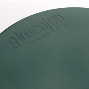 May include: A dark green cajon with the text "okecajon handmade in Istanbul" embossed on the front.