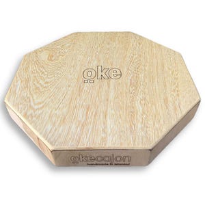May include: An octagonal wooden box with a light wood grain finish. The word "oke" is printed on the top, and "okecajon handmade in istanbul" is printed on the side. The box has a natural, minimalist aesthetic.