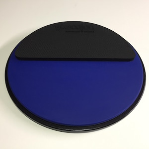 May include: A blue and black practice drum pad with the text "Rock Steady" printed on the black surface.
