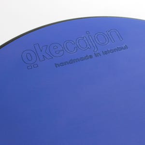 May include: A blue cajon with black trim and the text "okecajon handmade in Istanbul" printed on the front.