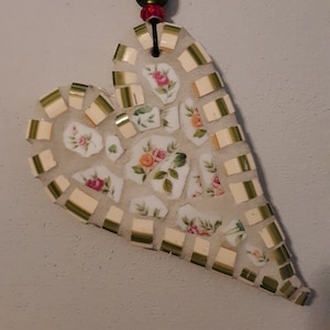 Mosaic heart- home decor. hanging art a beautiful bed of pink roses framed in green.