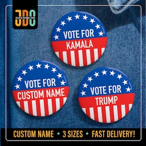 May include: Three red, white, and blue button pins with a star pattern around the edge. The buttons say "Vote for Kamala", "Vote for Custom Name", and "Vote for Trump".