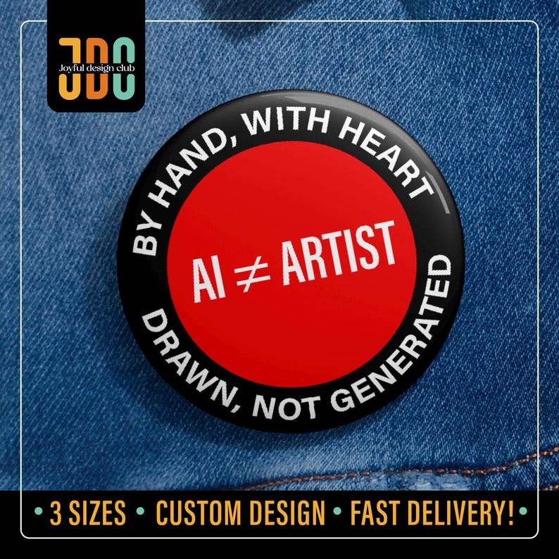 Red pin with black rim reading “AI ≠ Artist – Drawn, Not Generated – By Hand, With Heart.” Ideal for artists who value genuine hand-drawn creativity and craftsmanship.