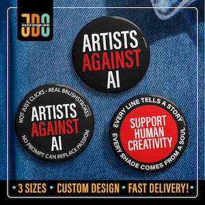 May include: Three black round buttons with white and red text. The buttons say "ARTISTS AGAINST AI" and "SUPPORT HUMAN CREATIVITY". The buttons are on a blue denim background. The bottom of the image says "3 SIZES CUSTOM DESIGN FAST DELIVERY!"