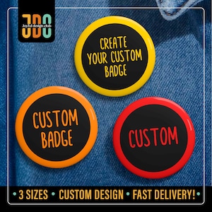 May include: Three custom button badges in yellow, orange, and red with black centers. The yellow badge reads "CREATE YOUR CUSTOM BADGE." The orange badge says "CUSTOM BADGE." The red badge says "CUSTOM."