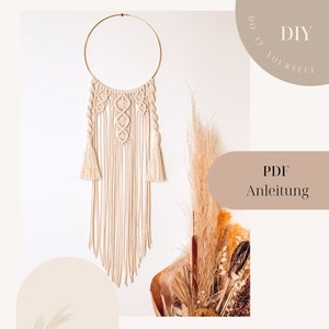 May include: Cream macrame dream catcher with a gold metal ring. The design features intricate knotting patterns, tassels, and long, flowing strands. The text "DIY" and "PDF Anleitung" are visible.