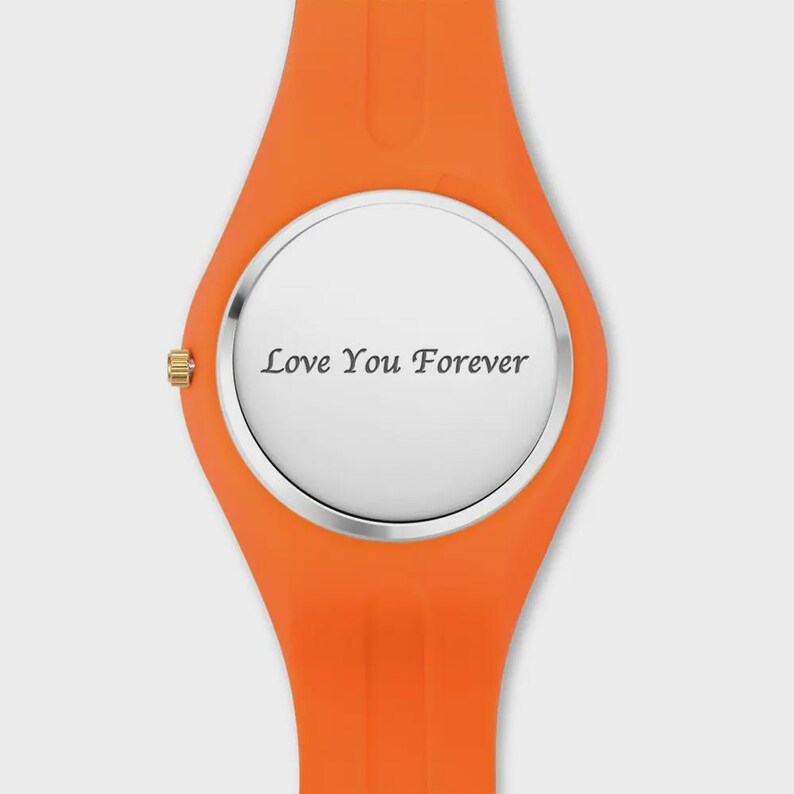 May include: Orange wristwatch with a silver face. The watch face displays the text "Love You Forever" in a simple, elegant font. The watch band is a bright orange color.