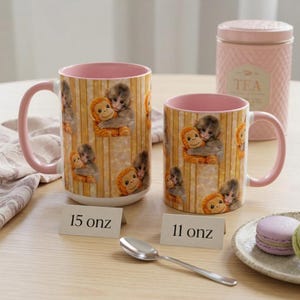 May include: A white ceramic mug with a black handle and the text "But First, Coffee" in a bold, black font. The mug is set against a blurred background, suggesting a cozy setting.