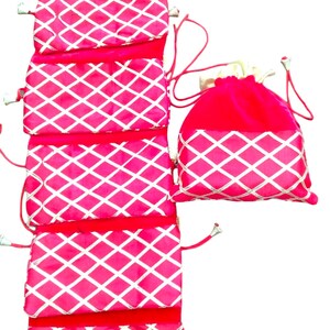 May include: Set of six pink drawstring bags with a white diamond pattern. The bags are lined up vertically, with the top bag folded over the one below it. The bags are made of a soft, velvety material.