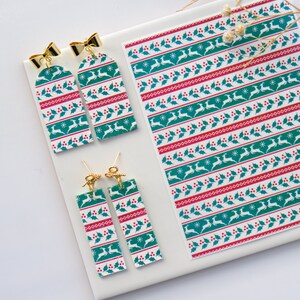 May include: A set of four Christmas-themed earrings featuring a green, red and white pattern with a reindeer design. The earrings are made of polymer clay and have gold-coloured findings.