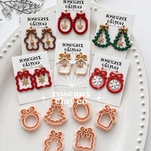 May include: A collection of holiday-themed polymer clay earrings on branded cards, featuring red, green, brown, and white designs like bows, wreaths, and trees, alongside six light peach-coloured plastic clay cutters in matching shapes.