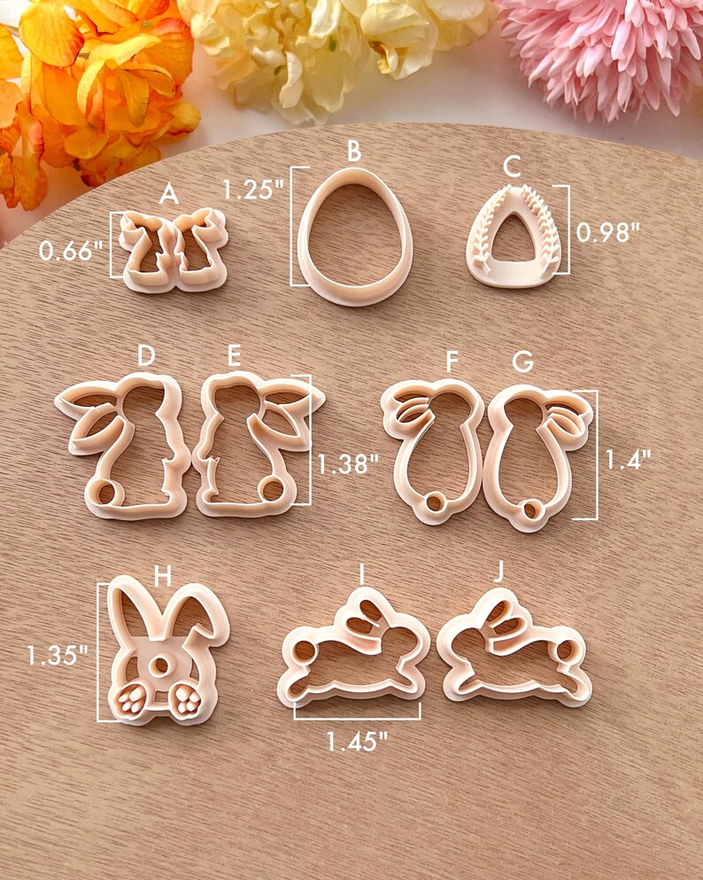 May include: Set of 10 cookie cutters in various shapes, including bunnies, eggs, and a heart. The cutters are made of white plastic and are approximately 1.25 inches to 1.45 inches in size.
