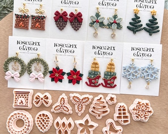 May include: A collection of handmade polymer clay earrings and cookie cutters. The earrings feature festive designs like Christmas trees, wreaths, and snowflakes. The cookie cutters are in various holiday shapes, including a fireplace and a bow.