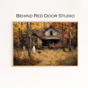 May include: Framed artwork showing a haunted house in a forest during autumn. The painting features a ghost, a black dog, and the text "BEHIND RED DOOR STUDIO". The color palette includes shades of brown, orange, and yellow.