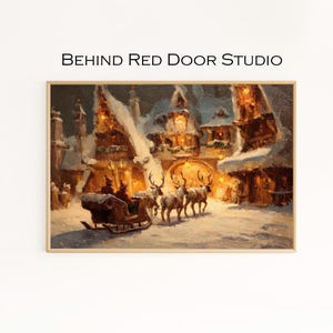 May include: A framed winter landscape painting featuring a horse-drawn sleigh led by reindeer in a snowy village. The artwork has a warm color palette with buildings and lights. The text "BEHIND Red Door STUDIO" is at the top.