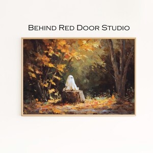 May include: A framed painting depicting a white ghost on a tree stump in a forest. The artwork uses a warm colour palette with autumn leaves and trees. The text "BEHIND RED DOOR STUDIO" is at the top of the image.