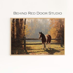 May include: A framed print depicting a brown and white horse in a field, near a wooden fence. The background shows a forest with autumnal trees. The text "BEHIND RED DOOR STUDIO" is displayed at the top of the print.