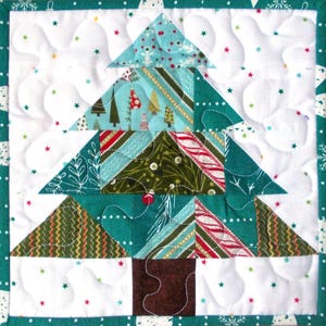 May include: A quilted Christmas tree wall hanging with a teal, green, and red patchwork design. The tree is surrounded by white snowflakes and stars.