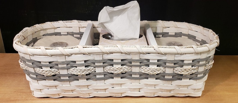 May include: White wicker basket with gray accents, divided into three sections. The center section holds a box of tissues, and the two side sections are empty.