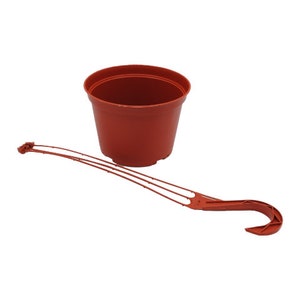 May include: A terracotta-colored plastic plant pot with a matching hanging bracket. The pot is round with a slightly flared rim. The bracket is long and slender, designed for hanging the pot.