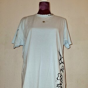 baby blue tee with silver and turquoise prints and metalware