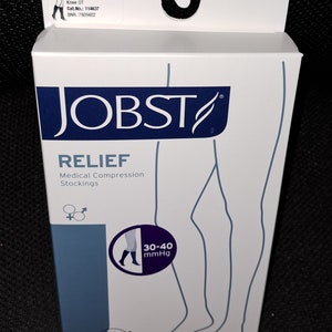 May include: A white box of JOBST RELIEF medical compression stockings. The box features the brand name and product details, including "30-40 mmHg" and "Knee OT." The box is beige and has a diagram of a leg. The box also includes the text "Medical Compression Stockings."