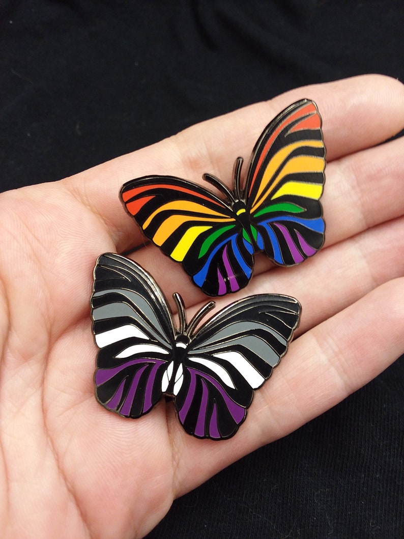 40 mm zebra butterfly hard enamel pins. One features the asexual flag color scheme; the other showcases the rainbow.