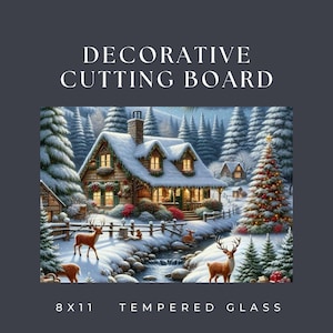May include: A rectangular tempered glass cutting board featuring a winter scene with a snow-covered cabin, a decorated Christmas tree, and deer. The text reads DECORATIVE CUTTING BOARD and 8 X 11 TEMPERED GLASS. The scene includes pine trees.
