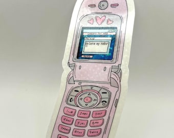 May include: A pink flip phone sticker with a screen displaying a text message that reads "delete my nabr :)". The phone has a keypad with numbers and letters, and three hearts above the screen.
