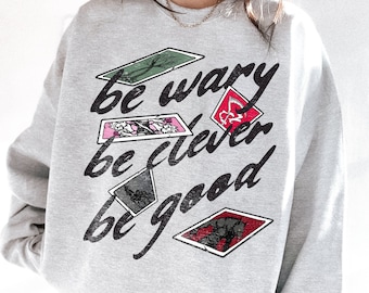 One Dark Window Sweatshirt | Be Wary Be Clever Be Good Licensed Shepherd King by Rachel Gillig Merch Elspeth Spindle Rayvn Yew Blunder Merch
