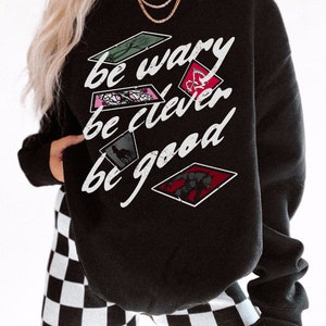 One Dark Window Sweatshirt | Be Wary Be Clever Be Good Licensed Shepherd King by Rachel Gillig Merch Elspeth Spindle Rayvn Yew Blunder Merch Black