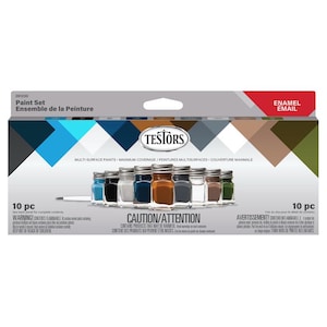 Op de afbeelding: Een verfset met tien kleine potjes emailverf in diverse kleuren, waaronder blauw, zwart, wit en bruin. De verpakking bevat de tekst "Paint Set" en "Testors", met een waarschuwing over ontvlambare inhoud.