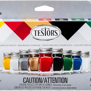 May include: A paint set box with the text "Paint Set" and "Ensemble de la Peinture". The box contains 10 small jars of enamel paint in various colors, including yellow, white, gray, brown, red, black, green, and blue. A white paintbrush is included.