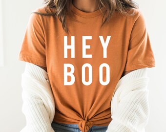 May include: A rust-colored t-shirt with the text "HEY BOO" printed in white.