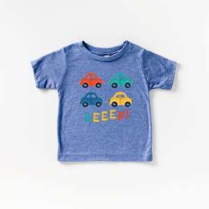 May include: A blue short-sleeved t-shirt with a graphic of colourful toy cars and the word "BEEEP!" printed on the front.