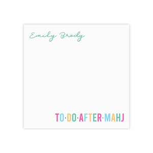 May include: White notepad with the text "Emily Brody" in teal script at the top and "TO DO AFTER MAHJ" in colorful block letters at the bottom. The notepad is square.