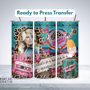 May include: A sublimation transfer sheet featuring a collage design with a portrait of a blonde woman, pink cassette tape, butterflies, leopard print, and text including "In Dolly We Trust," "Jolene Please Jolene," and "What Would Dolly Do?"