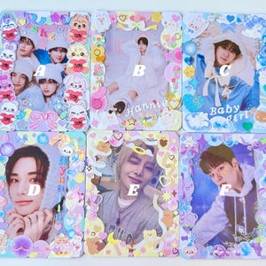 May include: Six decorative photo cards with colorful, whimsical frames. Each card features a different person, with text such as "Baby Girl" and "Stay". The frames are adorned with pastel-colored embellishments, including hearts, stars, and cartoon characters.