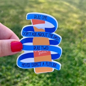 May include: A blue and white sticker with a cartoon orange juice bottle and the text "RULE ONE: DON'T ASK ABOUT THE PAST RULE TWO: Juice NEVER EXPECT A FUTURE".
