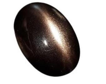 May include: A dark brown oval-shaped gemstone with a shimmering, iridescent effect.
