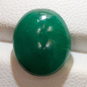May include: A smooth, oval-shaped green gemstone with a polished finish.