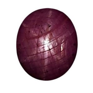 May include: A deep red star ruby gemstone with a cabochon cut. The stone has a star-like pattern visible on its surface.